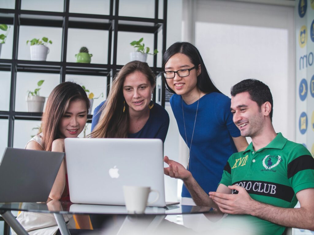 A team evaluating and comparing SEO agencies on a laptop