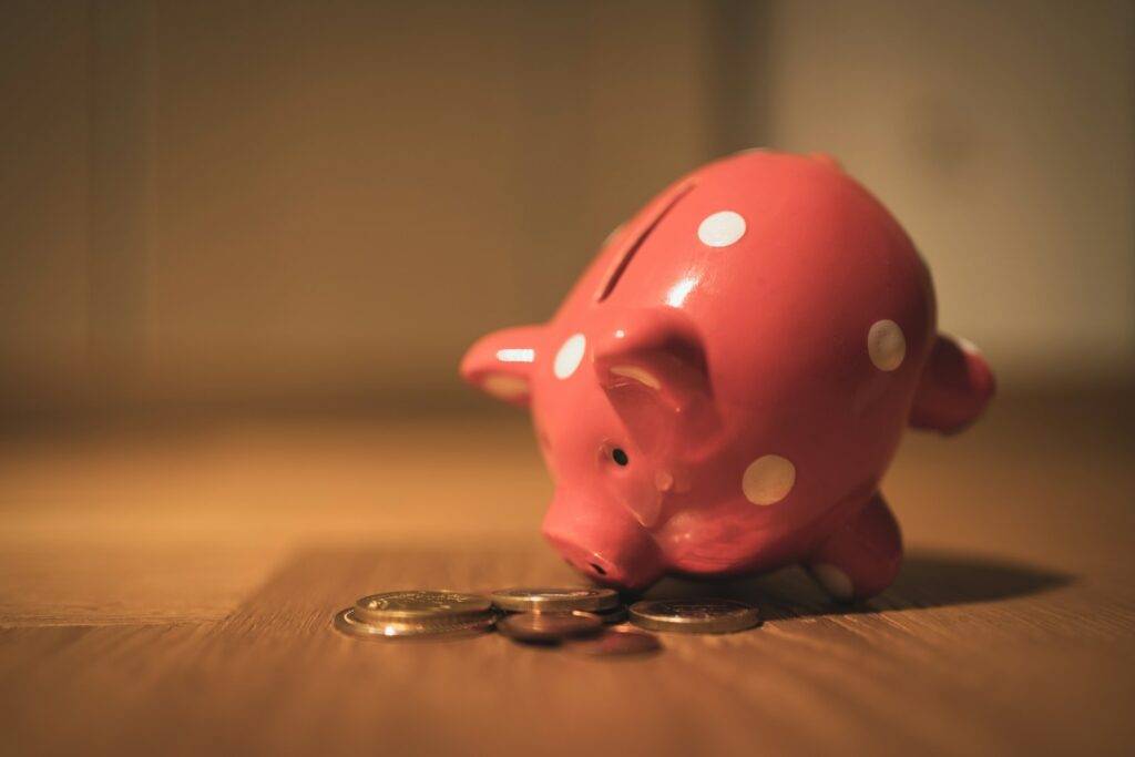 A piggy bank and coins representing the cost of SEO in the UK