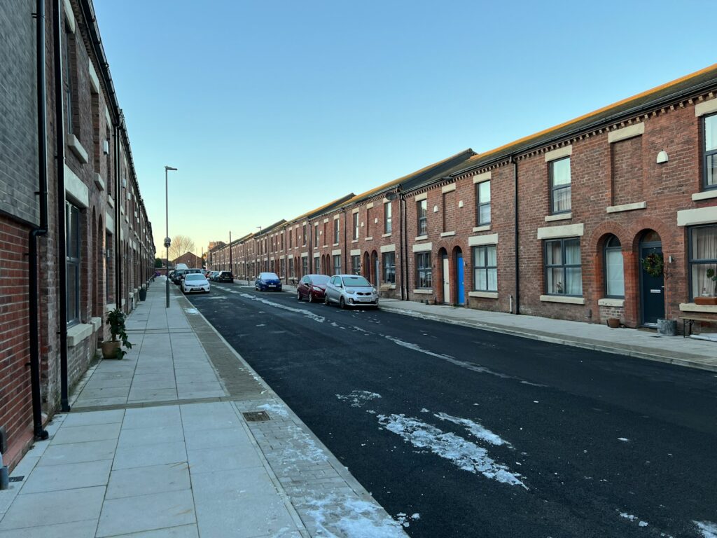 A row of UK terraced houses on a residential street, representing the local area where estate agents compete to get found on Google