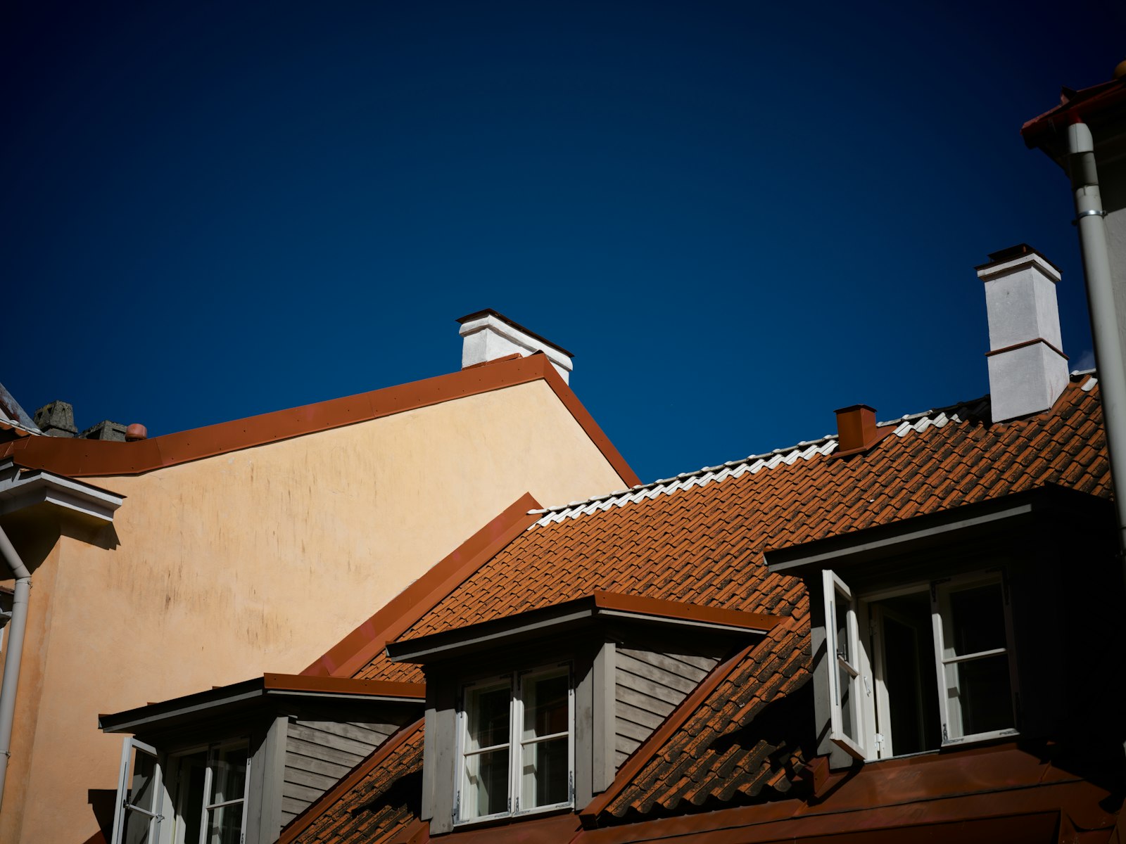 Tiled UK roofs with dormer windows, the kind of roofing work local roofer near me searches are looking for